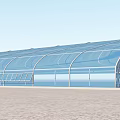 Modern Glass Building With Curved Roof In Green Grass And Paved Ground Area