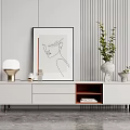 Modern White TV Stand With Drawers Open Compartment Green Plant Vase Lamp And Wall Art
