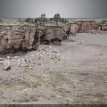 Natural Coastal Terrain With Red Rock Cliffs Sandy Beach Stones And Vegetation