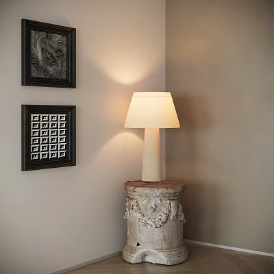 Lighted Table Lamp with Beige Shade on Carved Base Against Wall with Framed Art 3d model