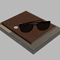 Brown Cover Notebook With Black Sunglasses On Stacked Books Light Background