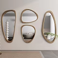 Irregular Shaped Wooden Framed Mirrors Mounted on Wall With White Spherical Decor And Green Plant