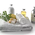 Essential Stylish Bathroom Accessories With Soft Towels Soap Liquid Bottles And Greenery