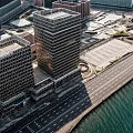 Modern Tall Buildings With Glass Facades And Ocean View At Sunset