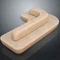 Elegant Beige Upholstered Curved Sofa With Modern Design And Smooth Surface