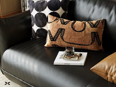 Stylish Throw Pillows on Black Leather Sofa with Brown Letter and Polka Dot Designs 3d model