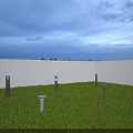 Outdoor Lights Illuminating Green Grass with White Wall and Evening Sky
