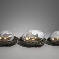 Three Decorative Eggs in Woven Nests with Gray White Shells and Gold Stars Inside