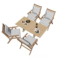 Wooden Outdoor Table with Four Cushioned Chairs Food Drinks and Magazine on Top