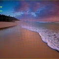 Natural Stones And Wood Elements On Beach At Sunset With Waves And Clouds