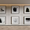 Black And White Abstract Artworks Framed On Wall With Wooden Floor
