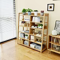 Modern Wooden Bookshelf With Books Potted Plants Storage Boxes And Decor In Living Room