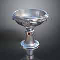 Silver Metal Goblet Shaped Sculpture Carving With Intricate Decorative Details And Red Gemstones On Base