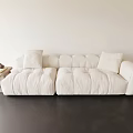 White Plush Three Seater Sofa With Soft Cushions And Side Table In Minimalist Living Room