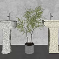 Two Textured Stone Washbasins With Golden Faucets And Potted Tree Against Gray Wall