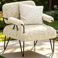Cream Fluffy Leisure Chair With Black Metal Frame And Geometric Pillow In Outdoor Garden