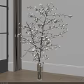 Transparent Glass Vase With White Flowering Branches Against White Wall And Wooden Floor