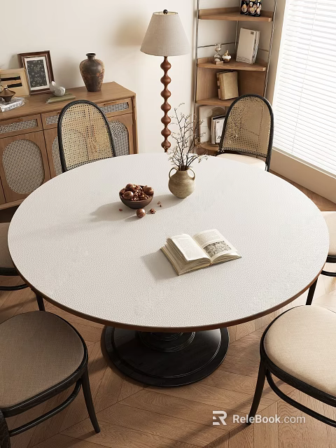 Round Table with Rattan Chairs Open Book Bowl of Nuts and Vase Near Wooden Cabinet 3d model 