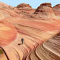 Red Rock Landscape With Wave Like Patterns And Standing Person Under Blue Sky 3d model