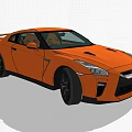 Orange Nissan GT-R Sports Car Parked In Green Grass With Trees Background