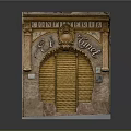 El Tunel Confiserie Storefront With Arched Yellow Roller Shutter And Stone Decorative Carvings