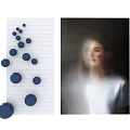 Wall Art with Blue Dots on Lined Paper and Blurred Person in White Shirt