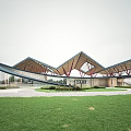 Modern Sales Office Building With Unique Roof Design Wooden Structure Green Lawn Entrance Area