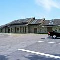 Highway Service Area With Buildings Parking Spaces And Green Areas Along Road Lanes