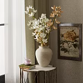 White Ceramic Vase with White and Beige Flowers on Small Table and Floral Painting