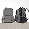Two Gray And Black Backpacks With Multiple Pockets Adjustable Straps On Wooden Platform 3d model