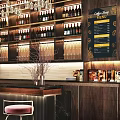 Cafe Bar Counter In Modern Interior With Wine Bottles Glasses And Stools