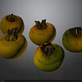 Five Fresh Persimmons With Yellow Orange And Green Hues On Dark Background