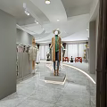 Modern Clothing Store Interior With Circular Display Mannequin Clothing Racks Marble Flooring And Dresses