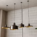Four Modern Dark Brown Gold Pendant Lights Hanging In Interior With Gray Wall White Grid