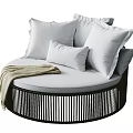 Round Outdoor Sofa with White Pillows Beige Blanket and Black Vertical Striped Frame