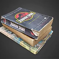 Worn Jurassic Park Book Stack With Other Books On Dark Background