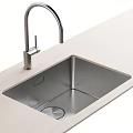 Stainless Steel Kitchen Sink With Faucet On Light Colored Modern Countertop