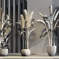 Three Indoor Potted Plants In Gray Ceramic Pots With Wooden Wall Background And Leaf Painting