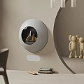 Modern Round Wall Mounted Fireplace With Wood Logs Inside Near Wooden Figurines On Minimalist Wall