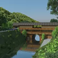 Scenic Garden Landscape With Wooden Arch Bridge Over Calm River And Lush Green Trees