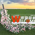 Welcome Home Sign Decorated With Pink White Flowers On Green Grass Sunset Sky