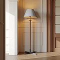 Modern Floor Lamp With Light Gray Fabric Shade Wooden Base Against Paneled Wall