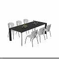 Black And White Dining Table With Chairs In Dining Room With Fruit And Bottle