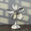 Floral Art Installation with Purple Petals Yellow Stamen and Green Stem in Interior