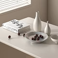 White Ceramic Vessels Including Bowls And Vases On Table With Books And Cherries