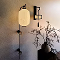 Chinese Style Wall Lamp with Patterned Round Lit Lampshade and Vase on Textured Wall