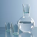 Two Transparent Drinking Glasses With Glass Bottle Containing Clear Liquid On Blue Tabletop