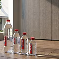 Vittel Water Bottles With Red Caps On Wooden Floor By Gray Cabinets And Window Tree
