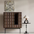 Wooden Decorative Cabinet With Geometric Pattern Above Wall Art And Side Table Lamp