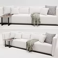 White Multi Person Sofa With Plush Pillows Throw Blanket And Side Table 3d model